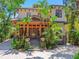 Beautiful two-story home featuring a wooden front porch and mature tropical landscaping at 3112 W Wallcraft Ave, Tampa, FL 33611
