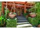 Gorgeous home showcasing a covered porch with wooden details and lush landscaping at 3112 W Wallcraft Ave, Tampa, FL 33611