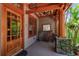Quaint front porch entrance with wooden architecture, rocking chairs and well maintained landscaping at 3112 W Wallcraft Ave, Tampa, FL 33611