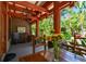 Charming front porch featuring comfortable seating, wooden beams and tropical landscaping at 3112 W Wallcraft Ave, Tampa, FL 33611