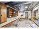Spacious home gym with workout equipment, overhead ductwork, and a large mirror for monitoring exercise form at 3112 W Wallcraft Ave, Tampa, FL 33611