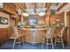 Custom kitchen and breakfast bar with wooden beam ceilings, unique lighting, and comfortable seating for entertaining at 3112 W Wallcraft Ave, Tampa, FL 33611