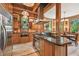 Spacious kitchen boasting custom wood cabinetry, granite counters, and stainless steel appliances, ideal for entertaining at 3112 W Wallcraft Ave, Tampa, FL 33611