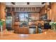 Well-appointed kitchen boasting stainless steel appliances, custom wood cabinetry, and a stylish breakfast bar for casual dining at 3112 W Wallcraft Ave, Tampa, FL 33611