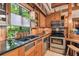 Gourmet kitchen showcasing stainless steel appliances, granite counters, wood cabinetry, and a sunlit window at 3112 W Wallcraft Ave, Tampa, FL 33611