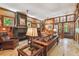 Warm living room with stone fireplace, wooden accents, and hardwood floors at 3112 W Wallcraft Ave, Tampa, FL 33611