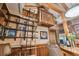 Home office featuring custom built-in wooden bookshelves, a ladder, soaring ceilings, and bar seating at 3112 W Wallcraft Ave, Tampa, FL 33611