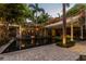 A tranquil courtyard pool surrounded by lush tropical landscaping and a covered lanai, perfect for relaxation at 3112 W Wallcraft Ave, Tampa, FL 33611