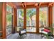 Relaxing sunroom with multiple windows, comfortable seating, and serene views at 3112 W Wallcraft Ave, Tampa, FL 33611