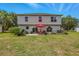 The backyard includes outdoor seating, a lush green lawn, and a patio at 31747 Loch Aline Dr, Wesley Chapel, FL 33545