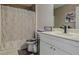 Neutral toned bathroom with shower and tub combination, vanity with framed mirror and art at 31747 Loch Aline Dr, Wesley Chapel, FL 33545