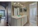 Bright bathroom featuring double mirrors, vanity with cabinets, and stylish lighting at 31747 Loch Aline Dr, Wesley Chapel, FL 33545