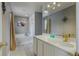 Bright bathroom features a soaking tub, white cabinets, and modern fixtures at 31747 Loch Aline Dr, Wesley Chapel, FL 33545