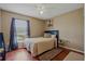 Comfortable bedroom features wood floors, neutral paint, and a large window at 31747 Loch Aline Dr, Wesley Chapel, FL 33545