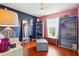 Stylish bedroom featuring hardwood floors, colorful walls, and ample natural light at 31747 Loch Aline Dr, Wesley Chapel, FL 33545