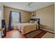 Bedroom features hardwood floors, bed with decorative pillows, and natural light at 31747 Loch Aline Dr, Wesley Chapel, FL 33545
