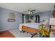 Charming bedroom featuring hardwood floors, a ceiling fan, and soft, blue walls at 31747 Loch Aline Dr, Wesley Chapel, FL 33545