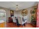 Charming dining room with wood floors, a large mirror, and modern chandelier at 31747 Loch Aline Dr, Wesley Chapel, FL 33545