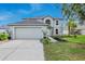 Inviting two-story home features a two-car garage, a manicured lawn and charming curb appeal at 31747 Loch Aline Dr, Wesley Chapel, FL 33545