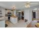 Open kitchen with island, stainless steel appliances, and eat in dining area at 31747 Loch Aline Dr, Wesley Chapel, FL 33545