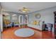 Spacious living room featuring hardwood floors, a ceiling fan, and neutral décor at 31747 Loch Aline Dr, Wesley Chapel, FL 33545