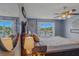 Primary bedroom overlooking lake offers serene water views, ceiling fan and decorative mirror at 31747 Loch Aline Dr, Wesley Chapel, FL 33545
