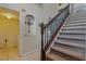 Staircase with carpeted stairs, wood railing, and views of the laundry room at 31747 Loch Aline Dr, Wesley Chapel, FL 33545