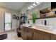 Bright bathroom features double sinks, modern fixtures, wood cabinetry, and decorative shelving at 3410 Briarwood Ln, Safety Harbor, FL 34695