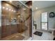 Modern bathroom featuring glass enclosed shower with rain shower head and stylish wood-look tile at 3410 Briarwood Ln, Safety Harbor, FL 34695