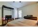 Well-lit bedroom with a ceiling fan, piano, and neutral decor at 3410 Briarwood Ln, Safety Harbor, FL 34695