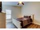 Bedroom featuring a white wooden bed frame, hardwood flooring, and a ceiling fan at 3410 Briarwood Ln, Safety Harbor, FL 34695