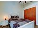 Bedroom featuring a white wooden bed frame, hardwood flooring, and closet at 3410 Briarwood Ln, Safety Harbor, FL 34695