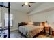 Cozy bedroom with a ceiling fan, neutral decor, wood floors, and natural light at 3410 Briarwood Ln, Safety Harbor, FL 34695