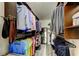 Spacious walk-in closet with custom shelving, hanging rods, and hardwood floors at 3410 Briarwood Ln, Safety Harbor, FL 34695