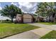 Landscaped home on a corner lot with a beautiful yard, and driveway at 3410 Briarwood Ln, Safety Harbor, FL 34695