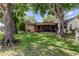 Charming home with a well-maintained lawn and a screened patio, surrounded by mature trees at 3410 Briarwood Ln, Safety Harbor, FL 34695