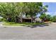 Charming home with mature trees, a screened patio, and a well-manicured lawn at 3410 Briarwood Ln, Safety Harbor, FL 34695