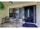 Welcoming front porch with seating area and decorative front door at 3410 Briarwood Ln, Safety Harbor, FL 34695