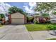 Charming single-story home with well-manicured lawn, mature landscaping, and inviting curb appeal at 3410 Briarwood Ln, Safety Harbor, FL 34695