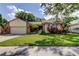 Charming single-story home with well-manicured lawn, mature landscaping, and inviting curb appeal at 3410 Briarwood Ln, Safety Harbor, FL 34695