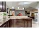 Modern kitchen with dark cabinetry, marble countertops, and sleek pendant lights at 3410 Briarwood Ln, Safety Harbor, FL 34695