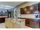Elegant kitchen with island, dark cabinets, granite counters, and tile backsplash at 3410 Briarwood Ln, Safety Harbor, FL 34695
