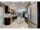 Open concept kitchen with stainless steel appliances, dark cabinets and center island at 3410 Briarwood Ln, Safety Harbor, FL 34695