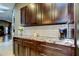 Modern kitchen with dark cabinetry, stainless appliances, and granite countertops at 3410 Briarwood Ln, Safety Harbor, FL 34695