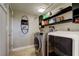 Well-equipped laundry room with modern washer, dryer, and storage shelves at 3410 Briarwood Ln, Safety Harbor, FL 34695