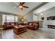 Inviting living room with hardwood floors, leather sofas, and a cozy atmosphere at 3410 Briarwood Ln, Safety Harbor, FL 34695