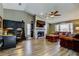 Bright living room with fireplace, ceiling fan, and comfortable seating arrangement at 3410 Briarwood Ln, Safety Harbor, FL 34695