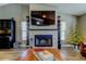 Living room featuring a stacked stone fireplace and decorative shelves at 3410 Briarwood Ln, Safety Harbor, FL 34695