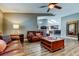 Comfortable living room with leather sofas, a ceiling fan, and views into the kitchen at 3410 Briarwood Ln, Safety Harbor, FL 34695