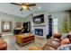 Open living room featuring a fireplace, modern decor, and views of the desk area at 3410 Briarwood Ln, Safety Harbor, FL 34695